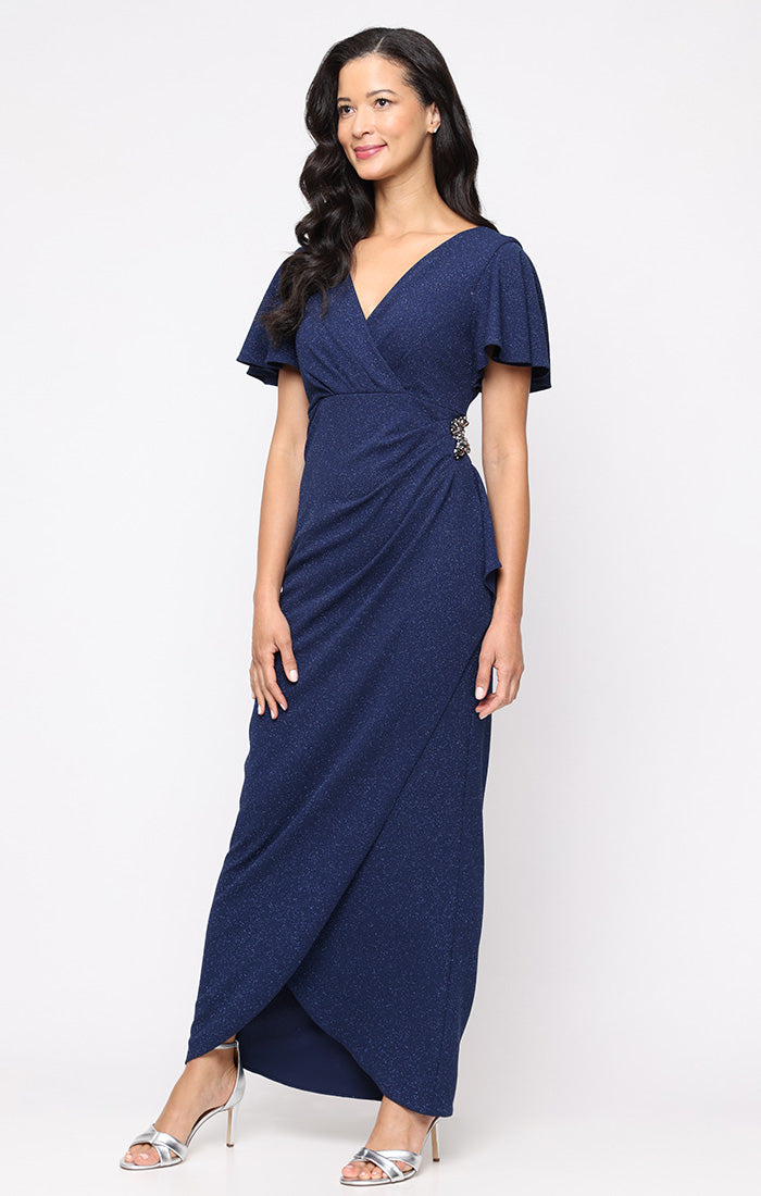 Long Empire Waist Dress with Surplice Neckline, Flutter Sleeves, Embellishment Detail at Hip and Cascade Skirt