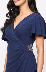 Long Empire Waist Dress with Surplice Neckline, Flutter Sleeves, Embellishment Detail at Hip and Cascade Skirt