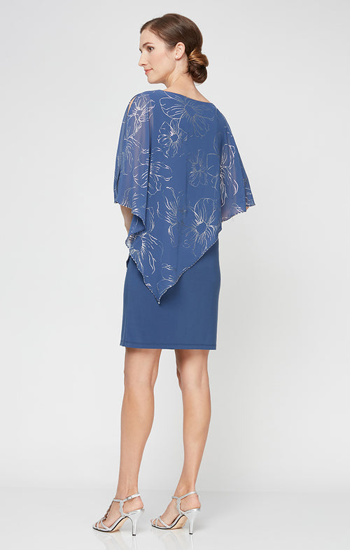 Woman wearing a blue dress with a matching shawl on a white background