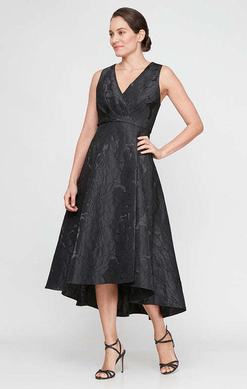 Woman wearing a black floral dress on a white background